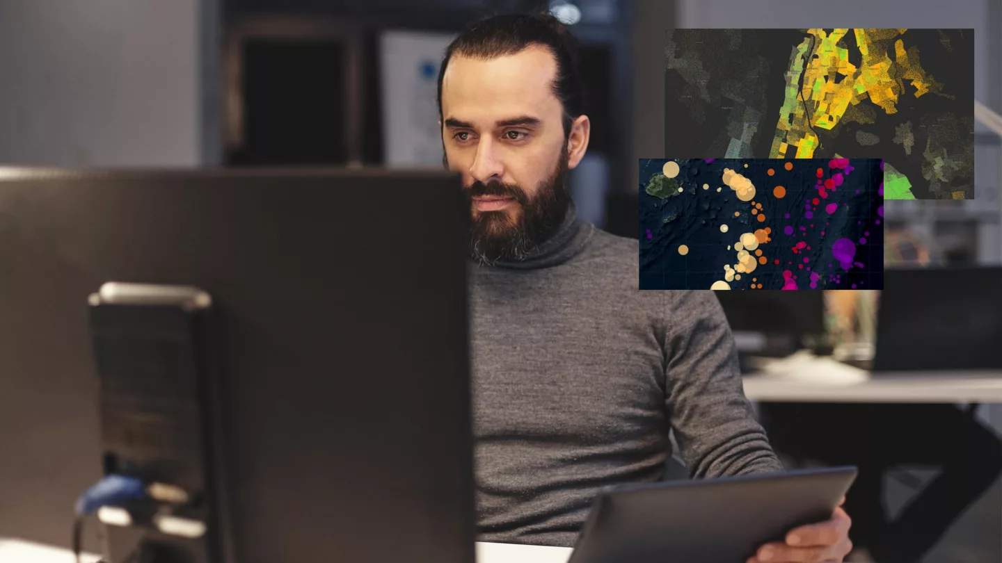 A man working with data on multiple screens